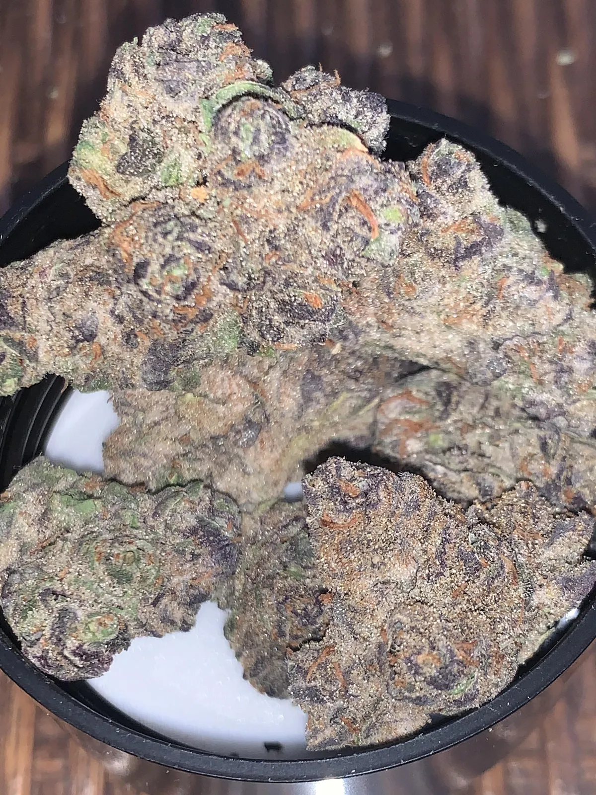 Close-up of potent, purple-hued cannabis buds covered in trichomes, found at a Vilanova I La Geltru social club.