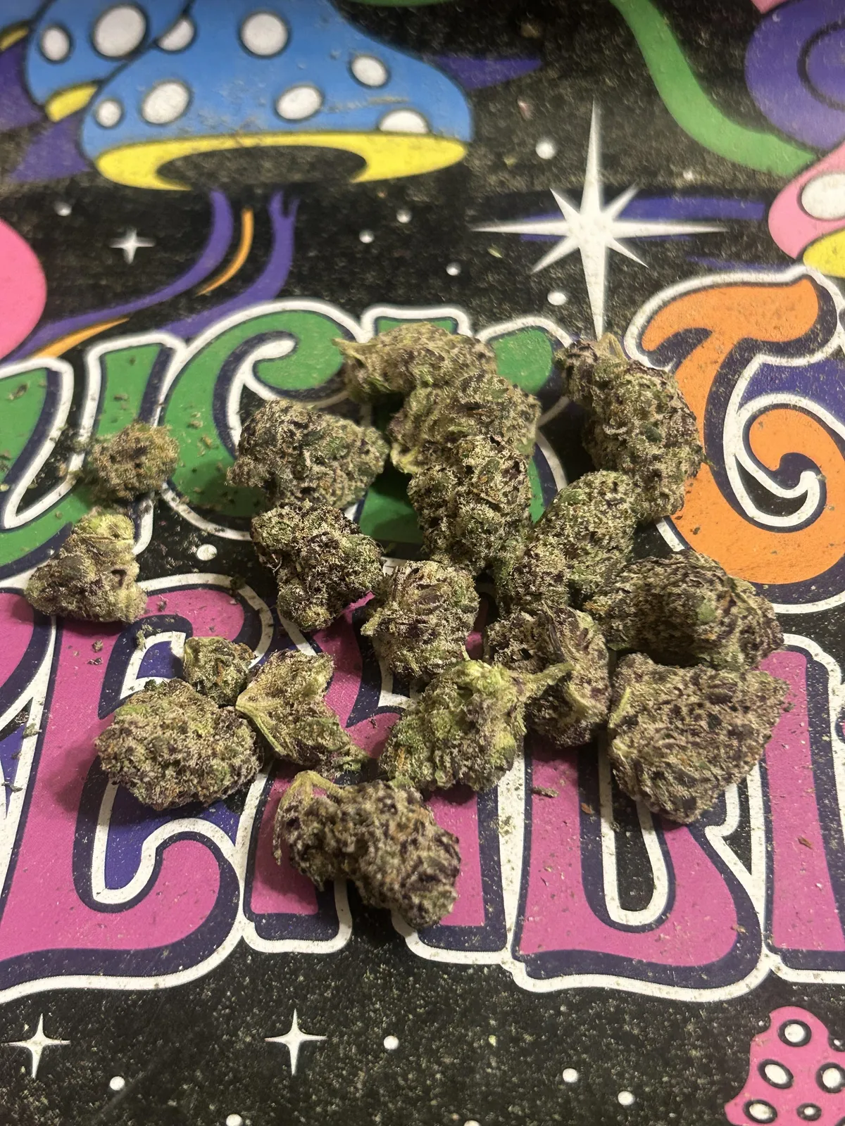 Vibrant cannabis buds with purple hues on a psychedelic background, typical of Tarragona's social clubs.
