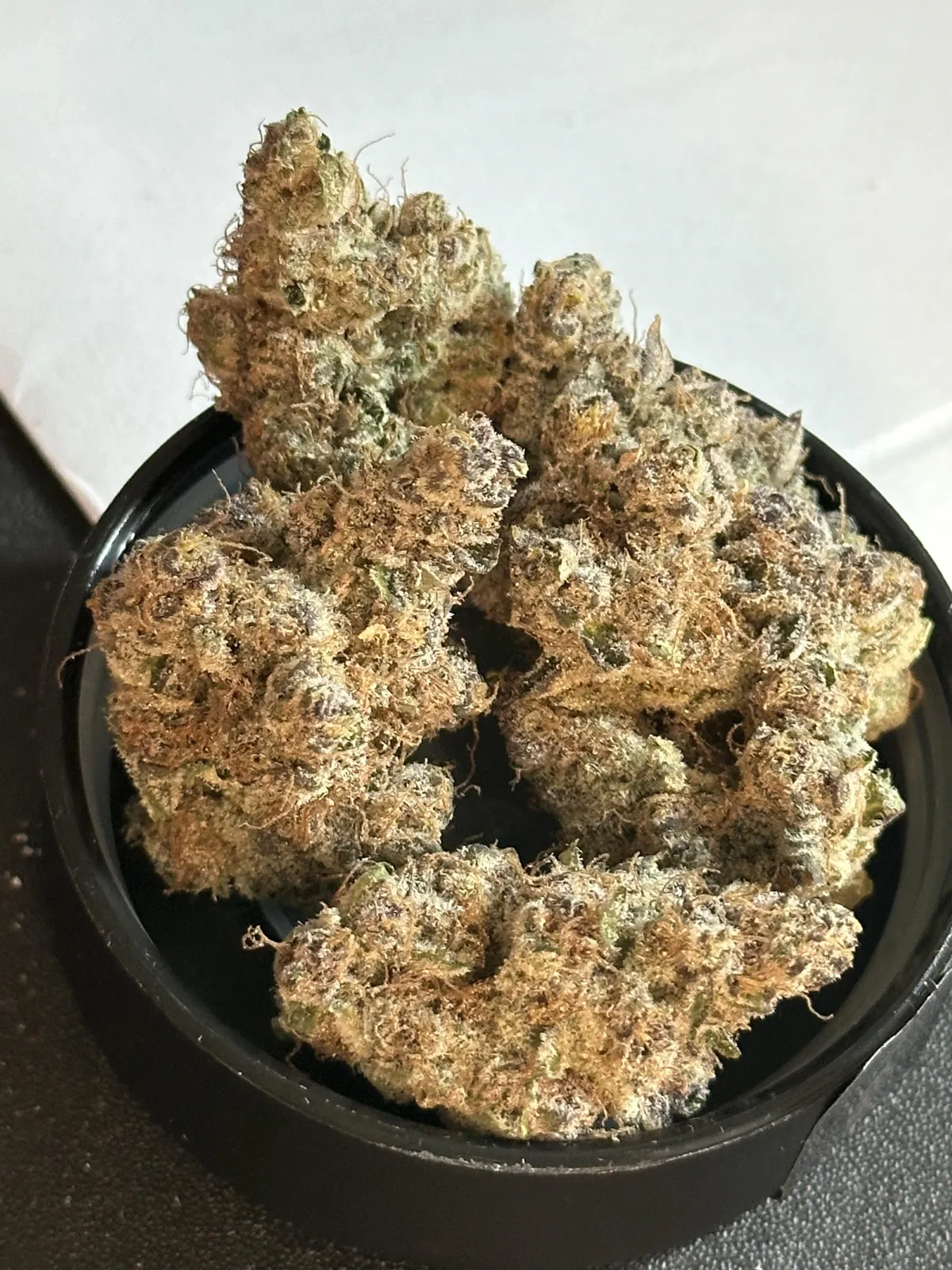 Trichome-rich cannabis buds in a container, ready for Barbate social club members to enjoy.